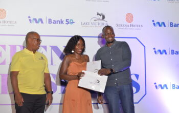 Gloria Nanyonga (middle) is awarded by I&M Bank Chief Finacial Officer Timothy Musiime (right) as Lake Victoria Serena Golf Resort Captain, John Muchiri looks