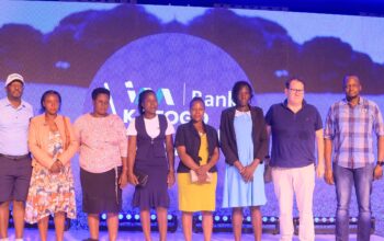 I&M Bank CEO Robin Bairstow (2R), Chief Financial Officer Timothy Musiime (R), and Katogo Golf Captain Elly Mukasa (L) share a joyful photo moment with some of the beneficiaries.